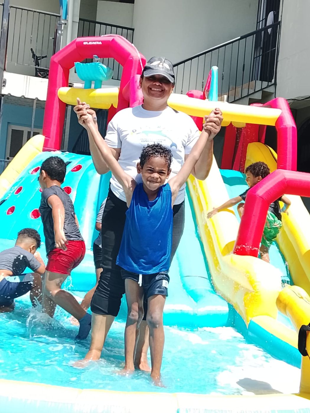 A Toba Foundation team member celebrating with a child during a therapeutic camp activity