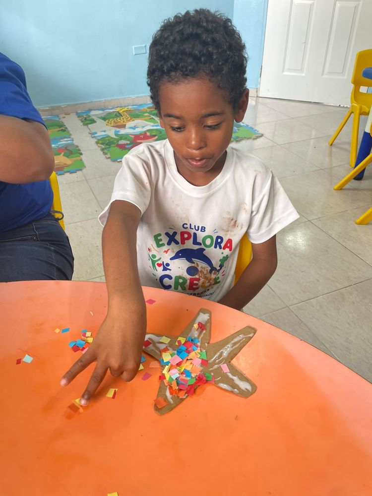 A child completing a sensory craft activity